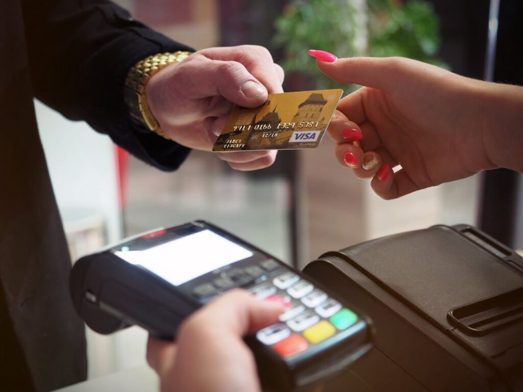 pexels-photo-2988232 Close-up of a credit card payment being processed at a POS terminal.
